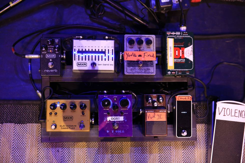 A collection of guitar pedals with various settings and labels, arranged on a pedalboard.