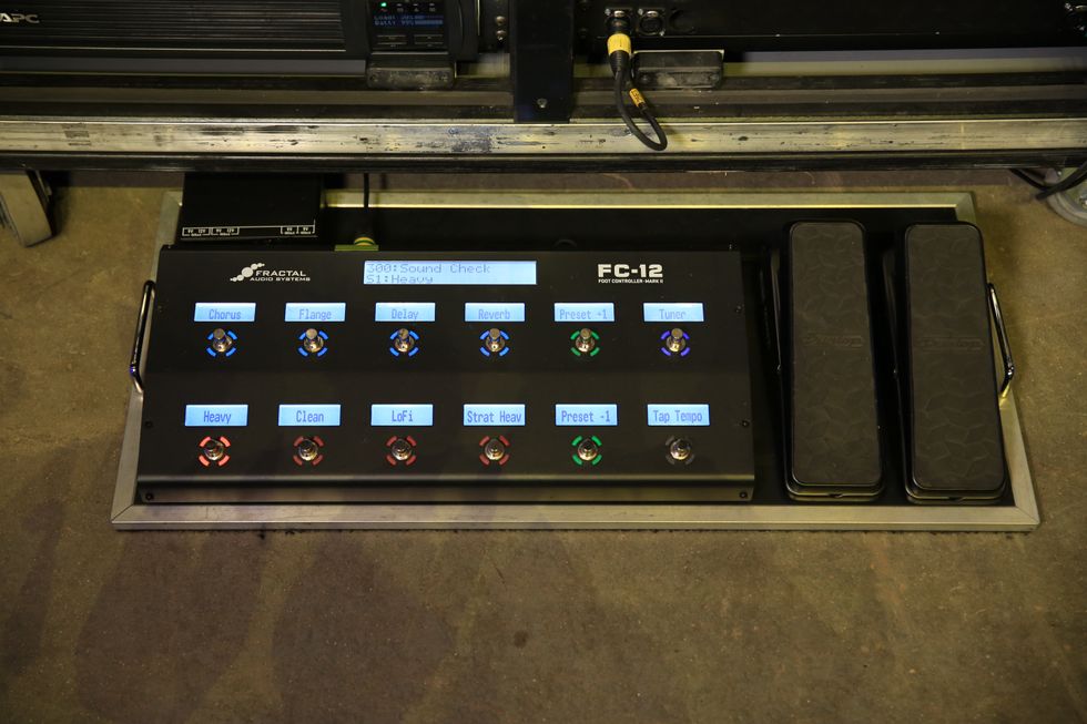 A foot controller with multiple switches and screens for audio effects and settings.