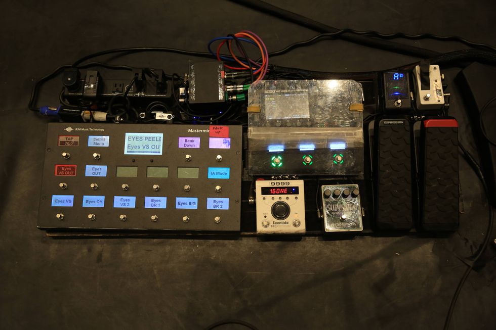 A music effects pedalboard with multiple buttons, switches, and LED indicators.