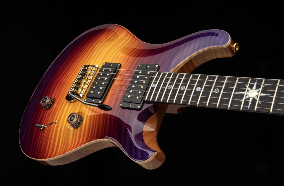 A vibrant, curly-top electric guitar with a multicolored finish and sleek design.