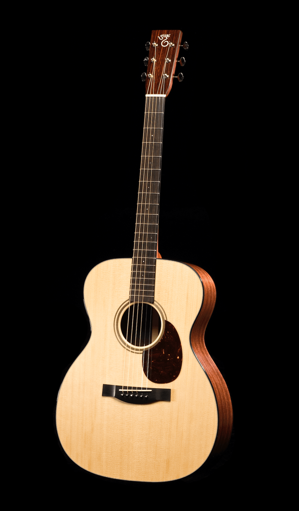 An acoustic guitar with a natural wood finish against a black background.