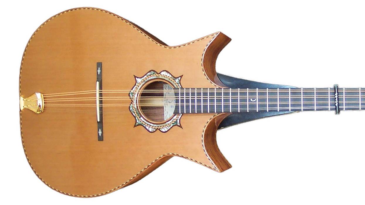An ornate acoustic guitar with a unique shape and intricate inlays.