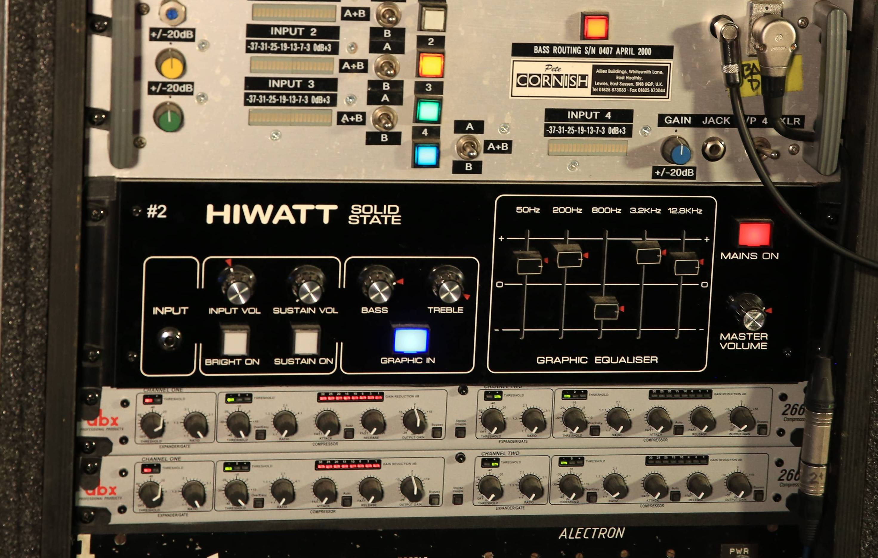 Audio equipment rack displaying various amplifiers and signal processors.