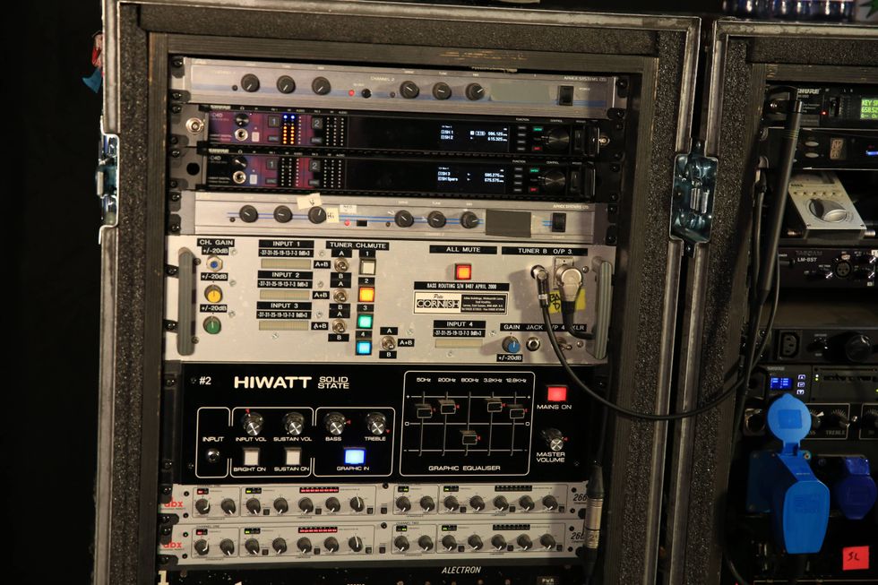 Audio equipment rack displaying various amplifiers and signal processors.