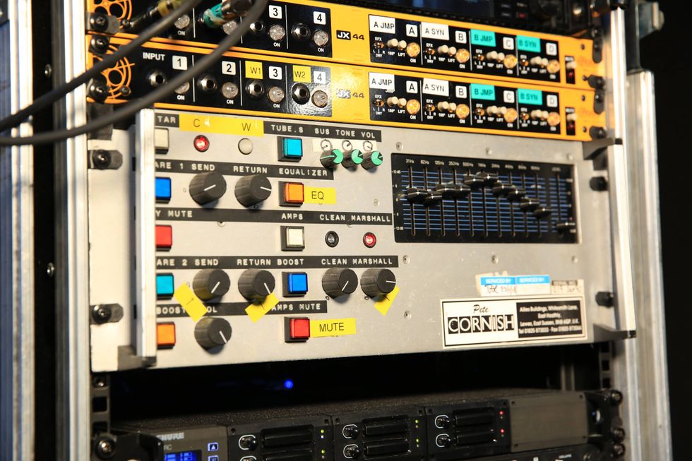 Audio equipment rack featuring diverse controls, switches, and equalizer settings.