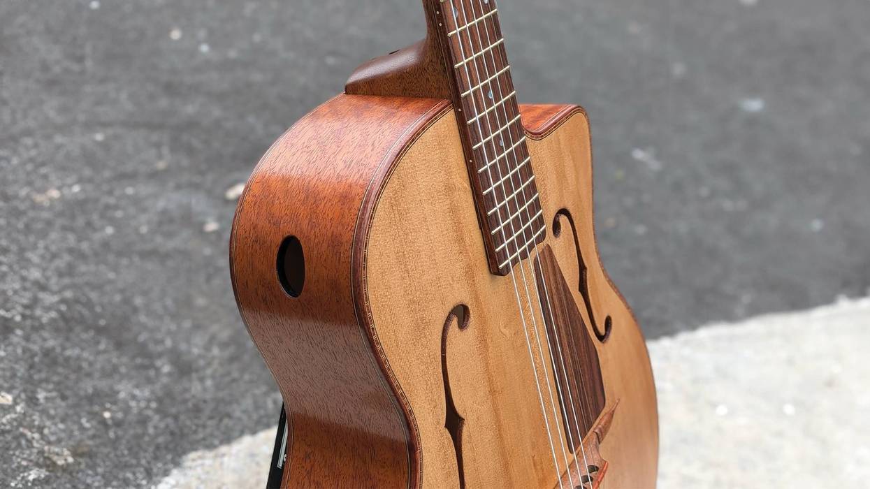 Close-up of a beautifully crafted acoustic guitar, showcasing its wooden body and strings.