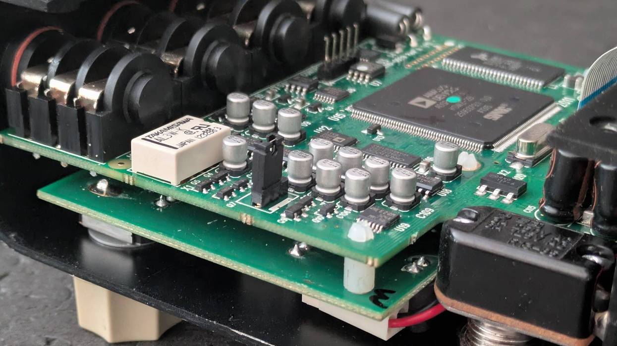 Close-up of a circuit board with components, mounted inside a black casing.