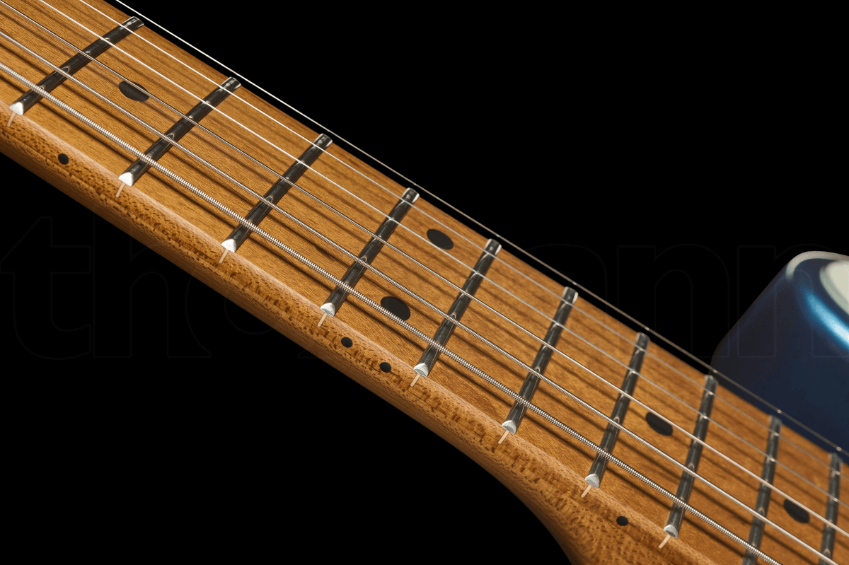Close-up of a guitar neck with frets and strings against a black background.