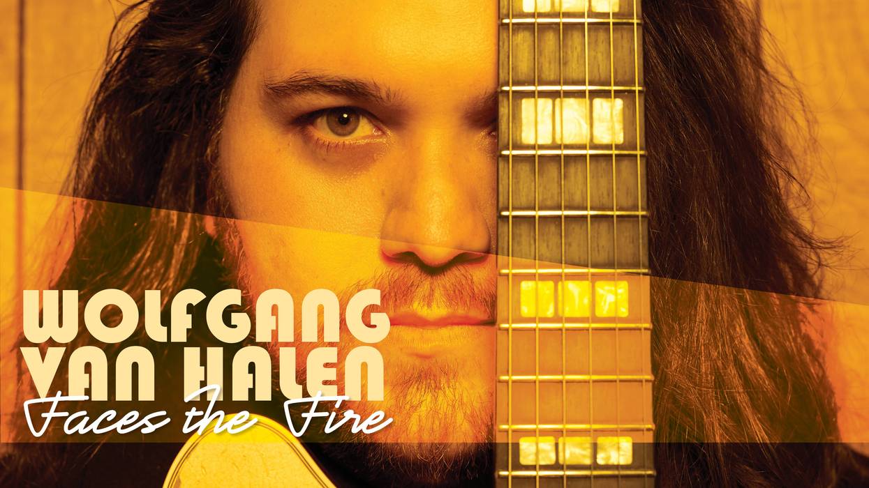 Close-up of a man with long hair, holding a guitar, titled "Wolfgang Van Halen: Faces the Fire."