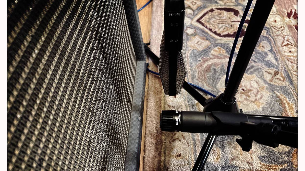 Close-up of a microphone and speaker on a patterned rug, ready for recording.