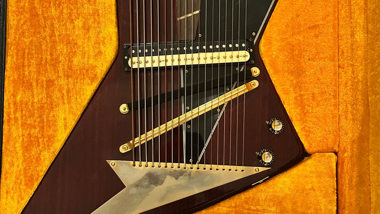 Close-up of a unique electric guitar with a striking design, resting in a velvet-lined case.