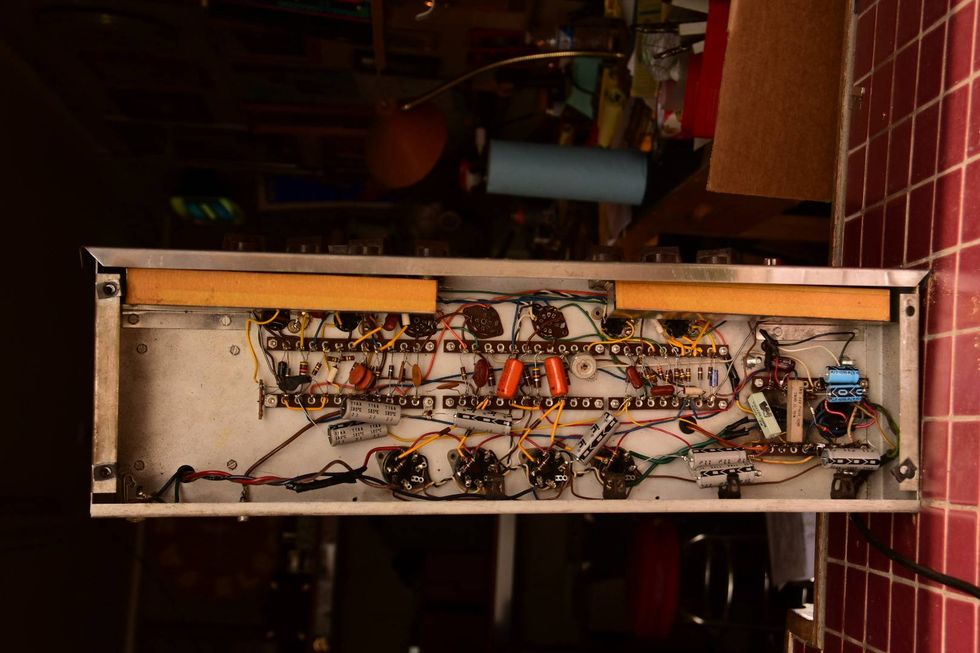 Close-up of complex electronic circuits and components inside a metal casing.