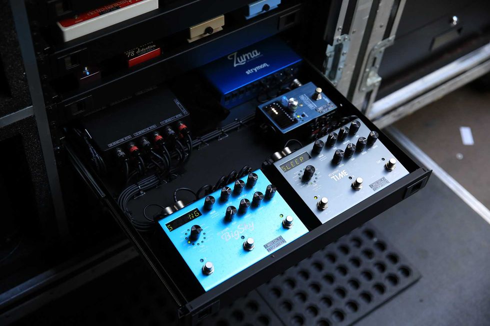 Close-up of guitar effects pedals in a rack, featuring BigSky, Time, and Sleep units.