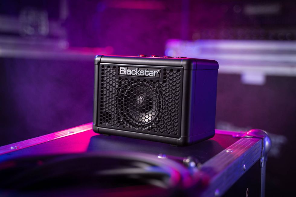 Compact Blackstar speaker on a reflective surface with purple lighting background.