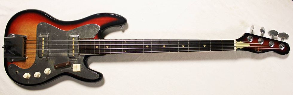 Electric bass guitar with a sunburst finish, four strings, and chrome hardware.
