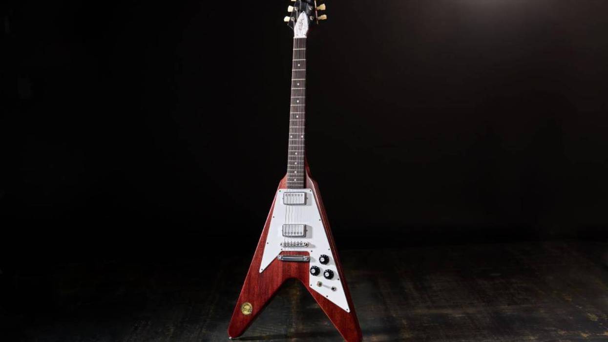 Electric guitar with a distinctive V shape, featuring a mahogany body and chrome hardware.