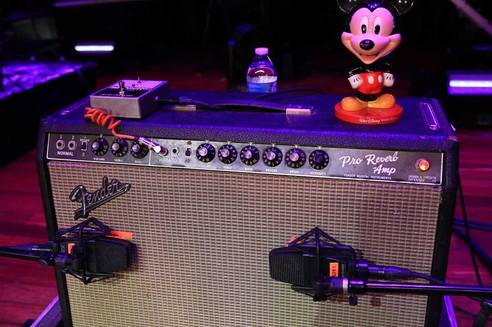 Fender Pro Reverb amp with microphone, guitar pedal, and a Mickey Mouse figurine on top.