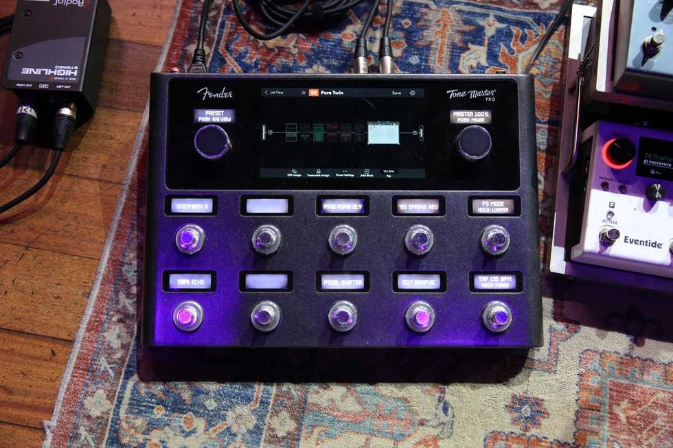 Fender Tone Master Pro pedalboard with various control buttons on a patterned rug.