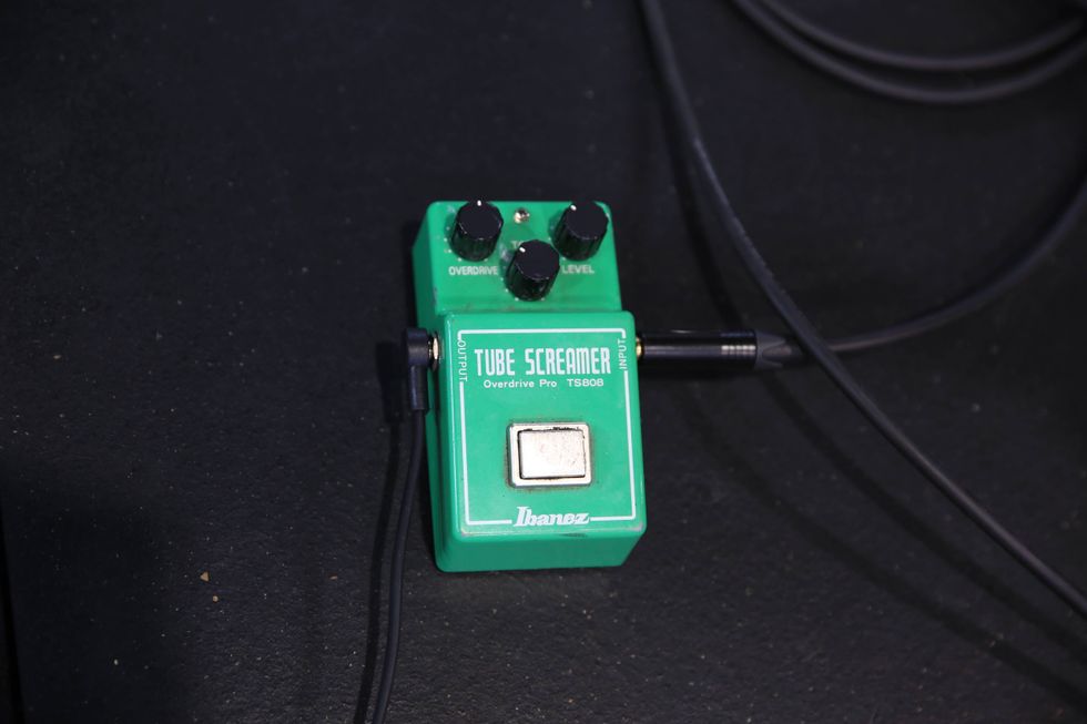 Green Ibanez Tube Screamer overdrive pedal with knobs for tone and level settings on a dark surface.