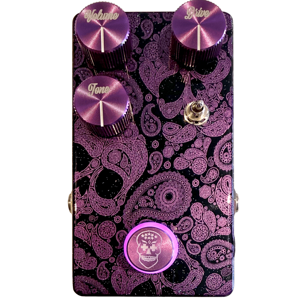 Purple guitar pedal with ornate paisley design, featuring controls for volume, tone, and drive.