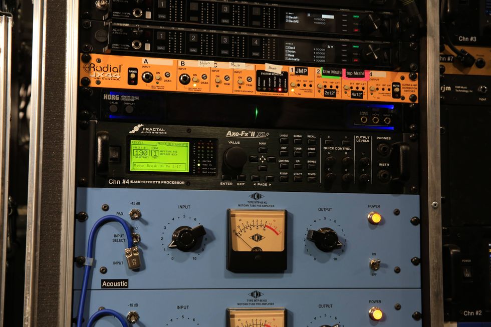 Rack-mounted audio equipment with various processors and effects units displayed.