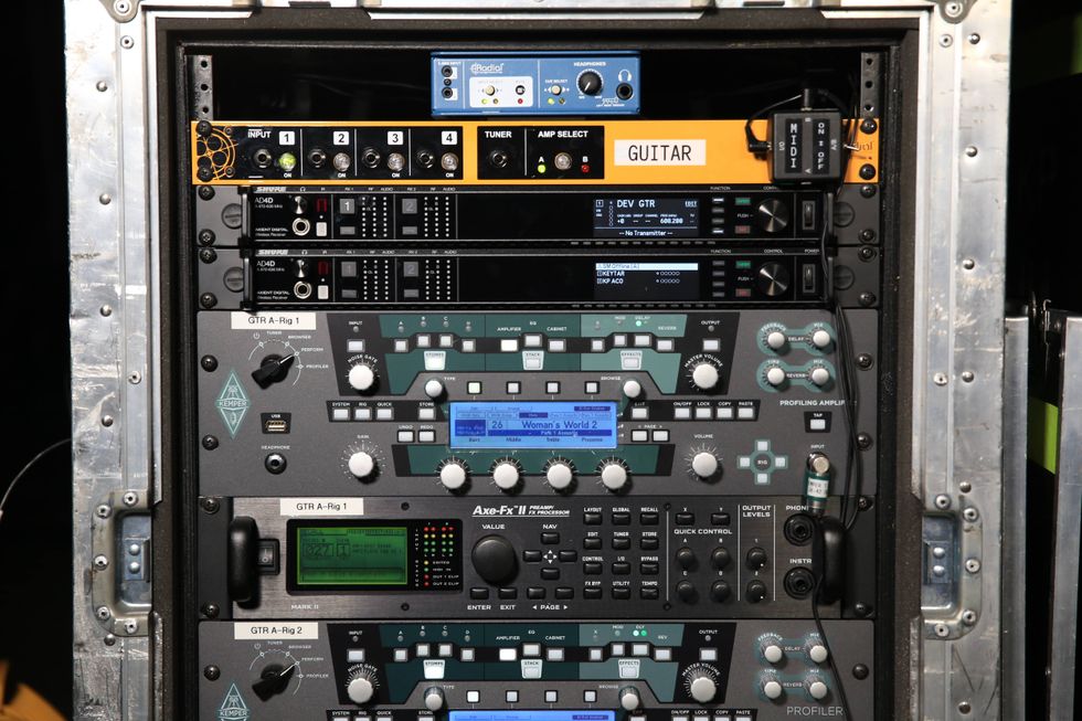 Rack-mounted guitar equipment with various processors and controls arranged in a professional setup.