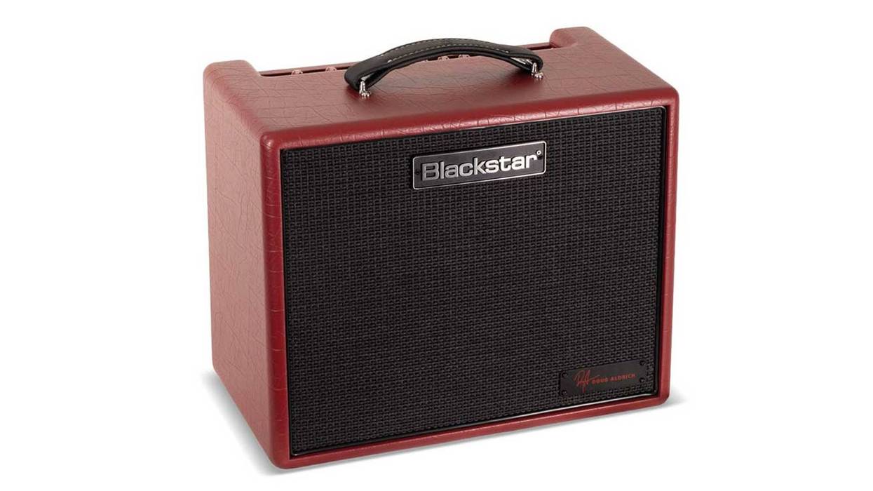 Red portable amplifier with a textured finish and a black speaker grille.