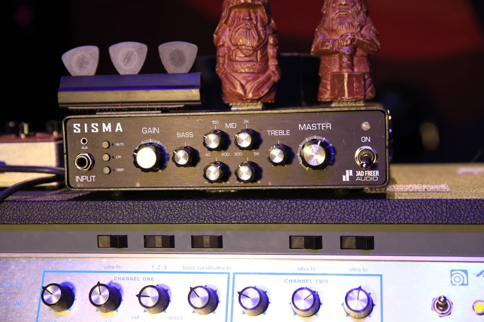 Sisma audio mixer on a speaker, adorned with two small, festive gnome figures.