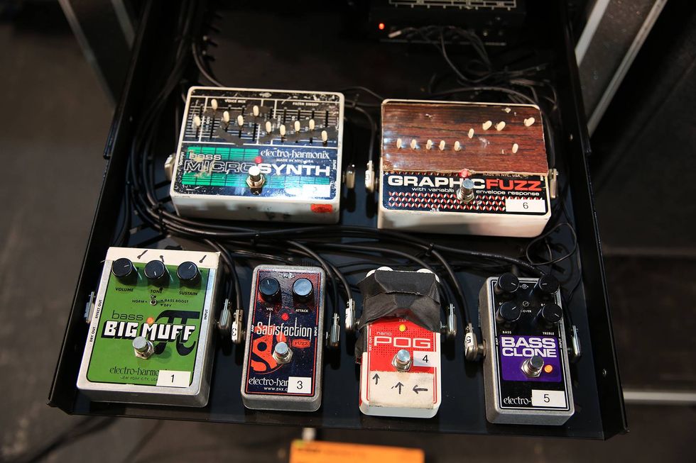 Six guitar effect pedals arranged in a rack, featuring various brands and models.