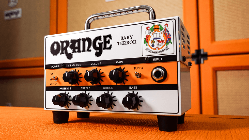 Small guitar amplifier with knobs, labeled "Orange Baby Terror," on an orange background.