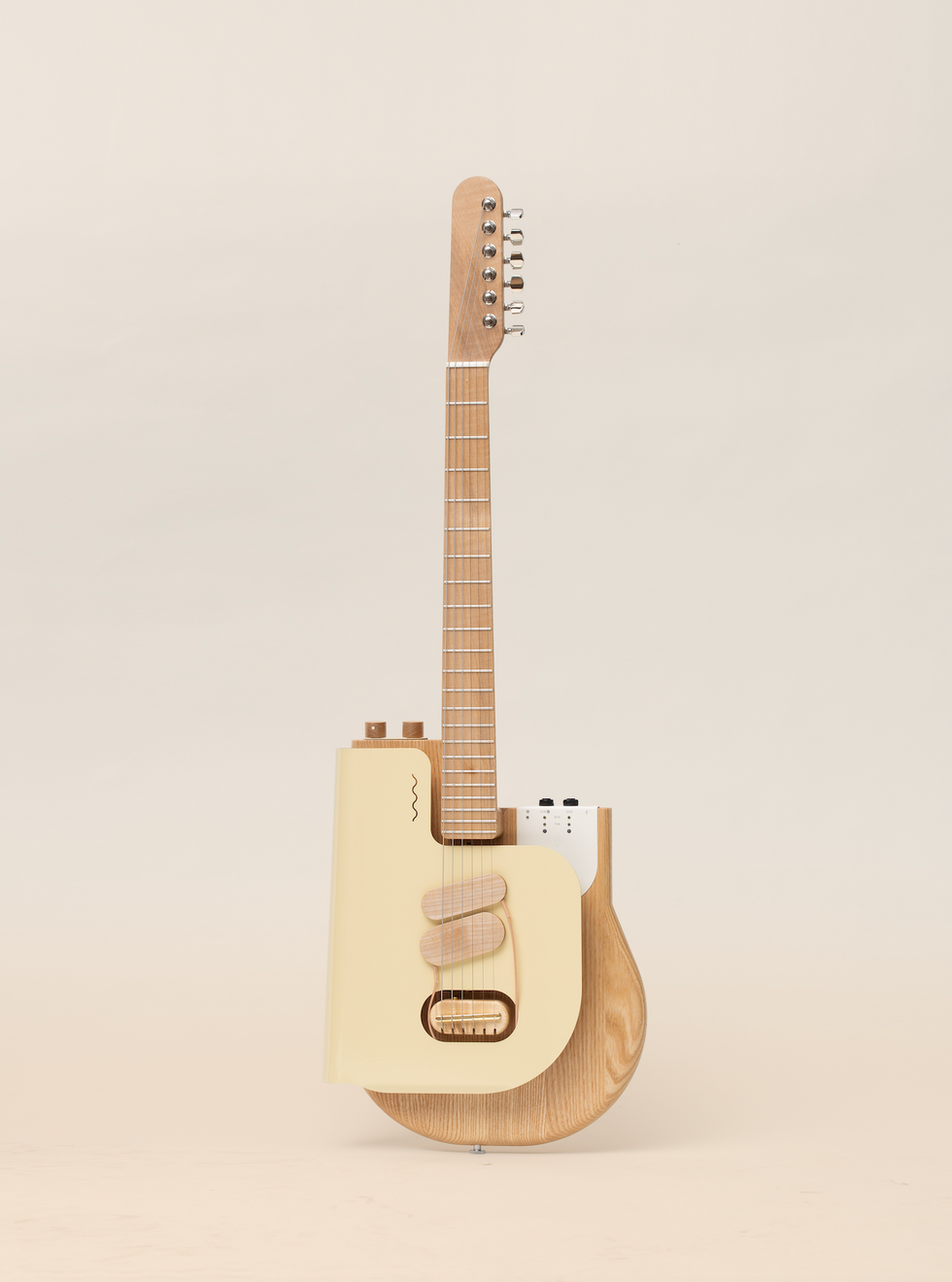 Stylish guitar with a unique design featuring a wooden neck and a cream-colored body.