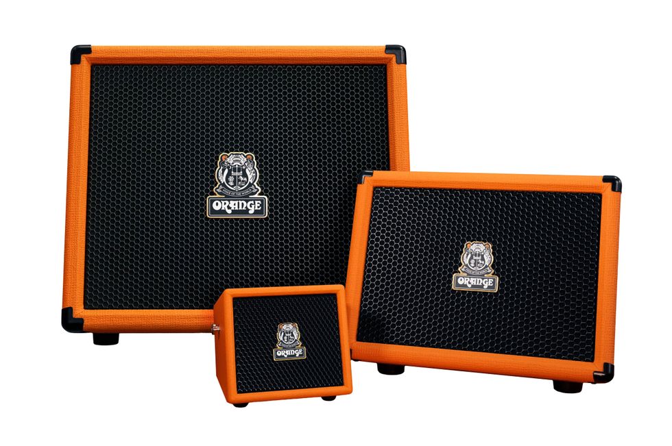Three Orange brand guitar amplifiers in varying sizes with black mesh fronts.