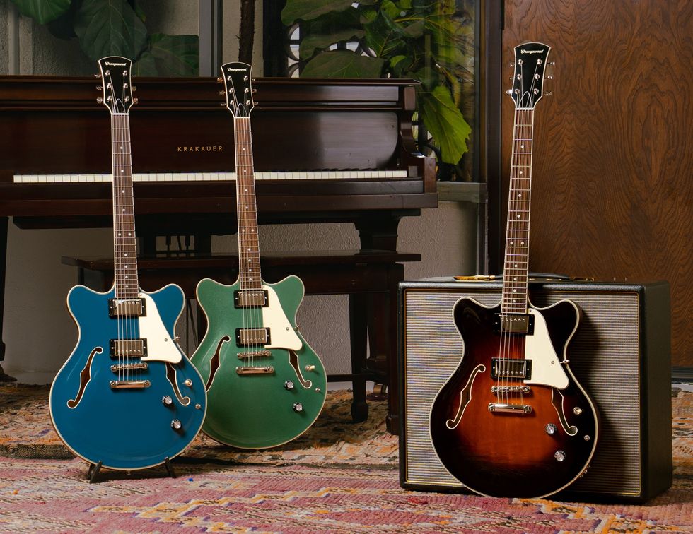 Three stylish electric guitars in blue, green, and brown, next to a vintage amplifier.